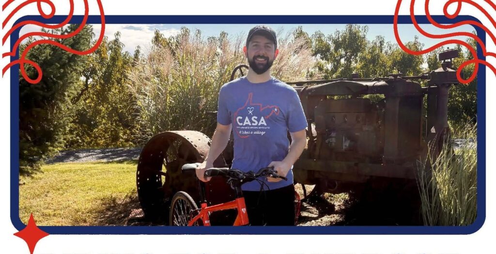 A promotional flyer featuring a man standing with a bicycle in front of old farm machinery, promoting a charity bike ride to support CASA of the Eastern Panhandle.