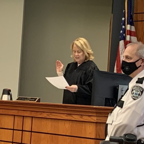 Judge McLaughlin hold up right hand
